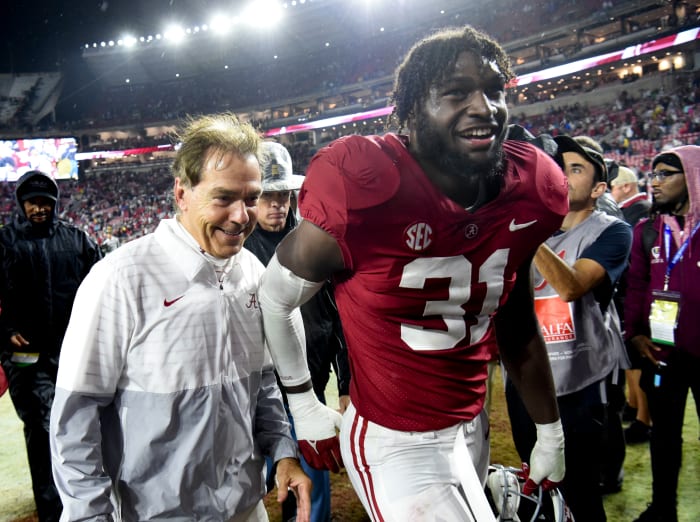 Crimson Tide head coach Nick Saban and linebacker Will Anderson Jr. (31) share a smile as they leave the field after defeating the Auburn Tigers at Bryant-Denny Stadium. Alabama won 49-27